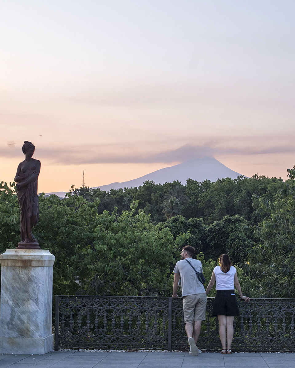 Un couple regarde l’Etna au loin depuis les hauteurs de Catane.